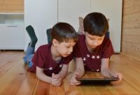 Two children using a digital device