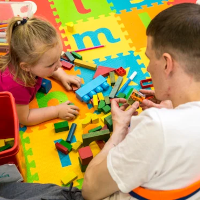 An adult playing a game with a child