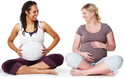 Two Pregnant women sitting with legs crossed