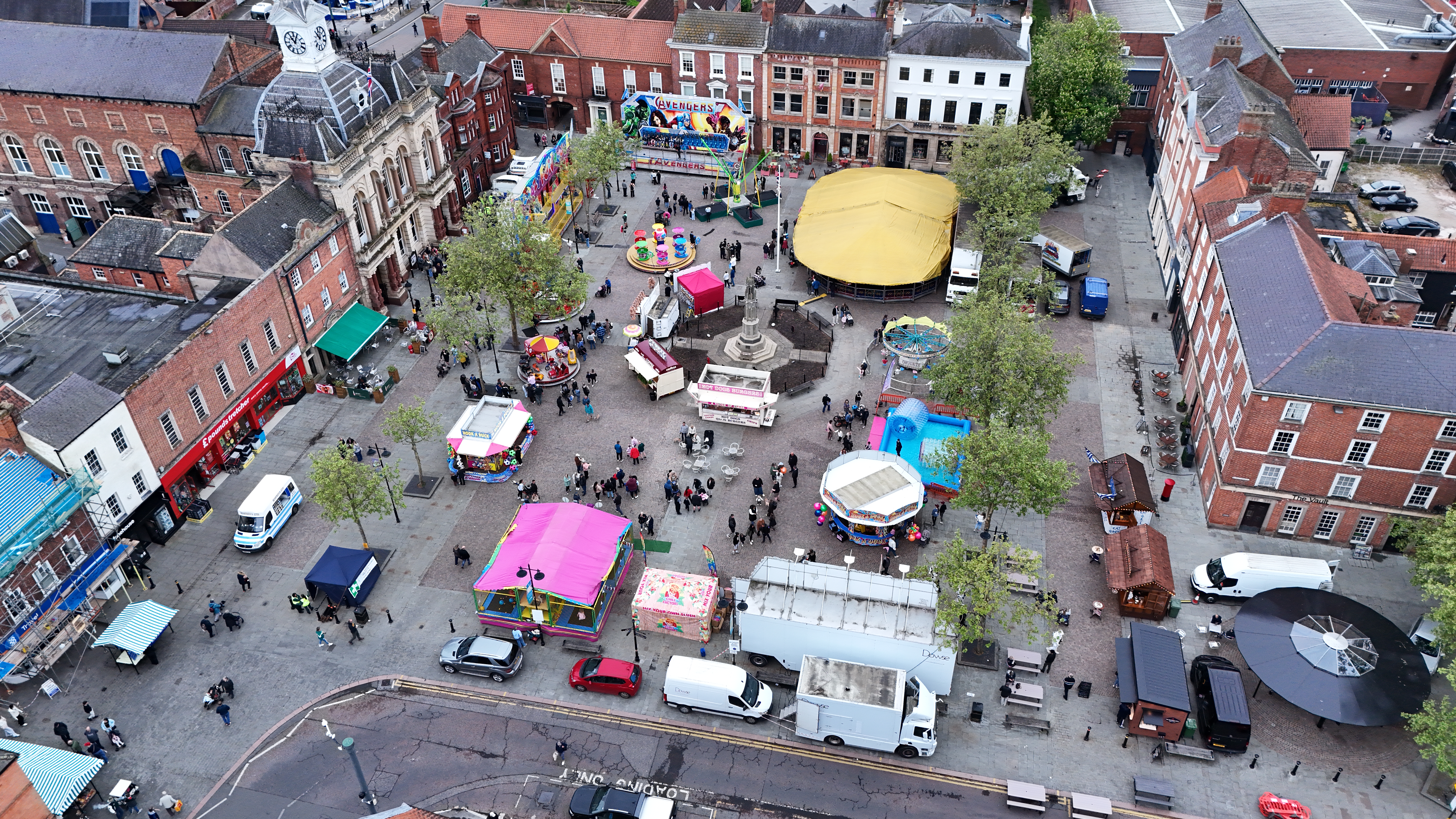 An aerial shot of Retford Market Square, filled with funfair rides.