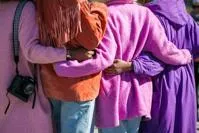 People with arms around each other